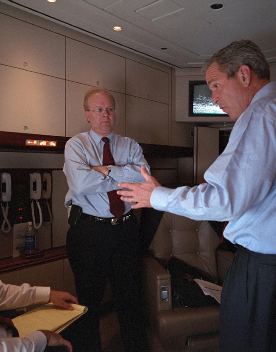 President George W. Bush speaks with Karl Rove (center) and Ari Fleischer, September 11, 2001, aboard Air Force One during the flight from Offutt Air Force Base in Nebraska to Andrews Air Force Base. (P7098-06)
