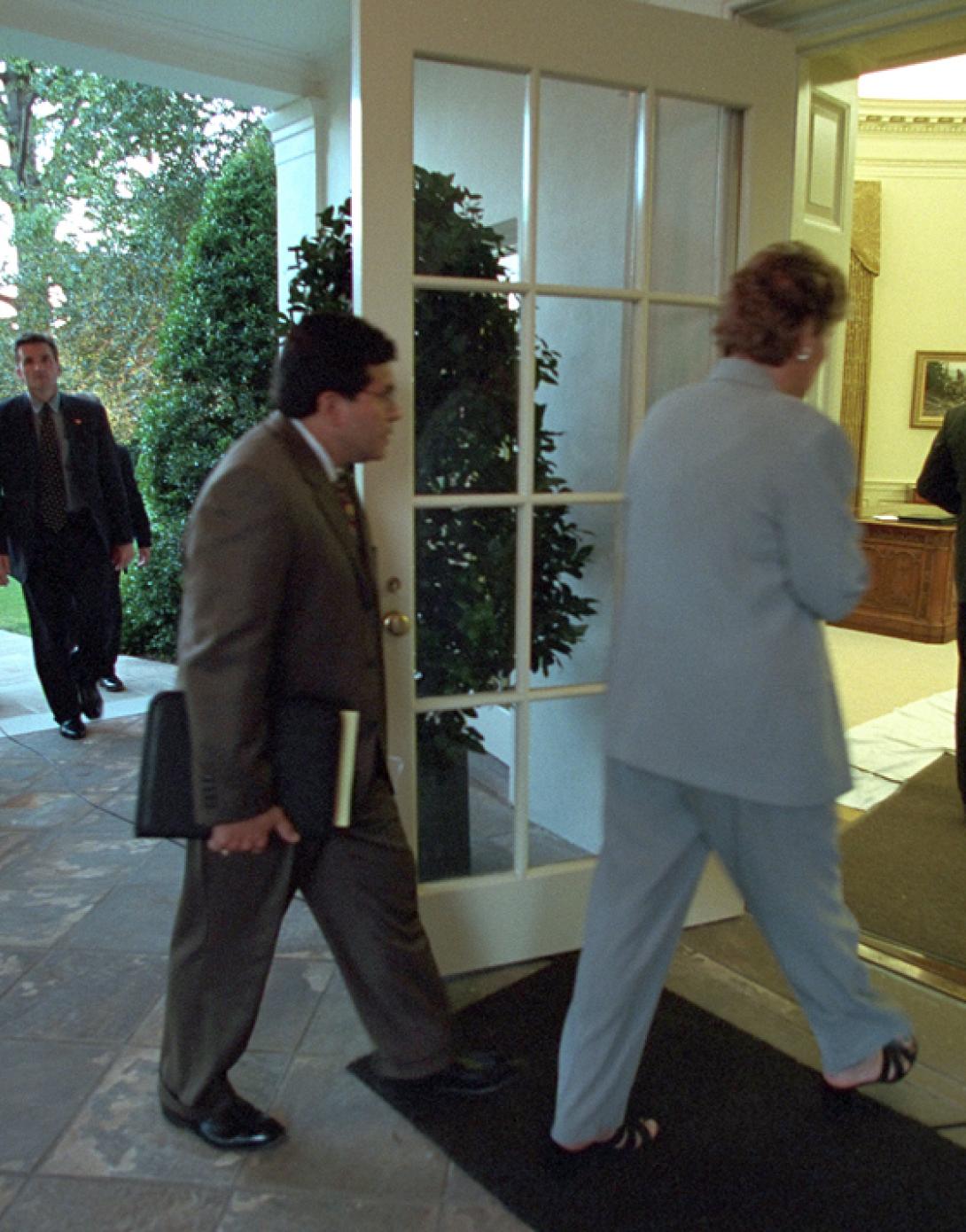 Counselor Karen Hughes and Counsel Alberto Gonzales follow President George W. Bush into the Oval Office, September 11, 2001. (P7110-08)