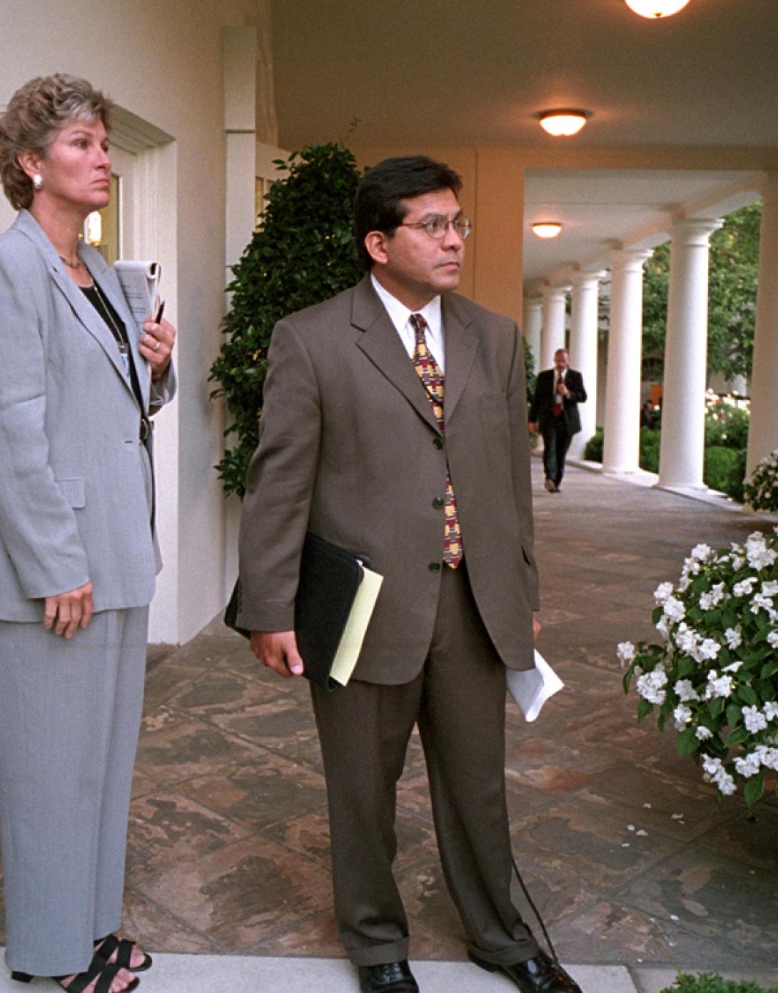 Counselor Karen Hughes and Counsel Alberto Gonzales wait on the Colonnade for President George W. Bush to arrive at the White House, September 11, 2001. (P7111-04a)