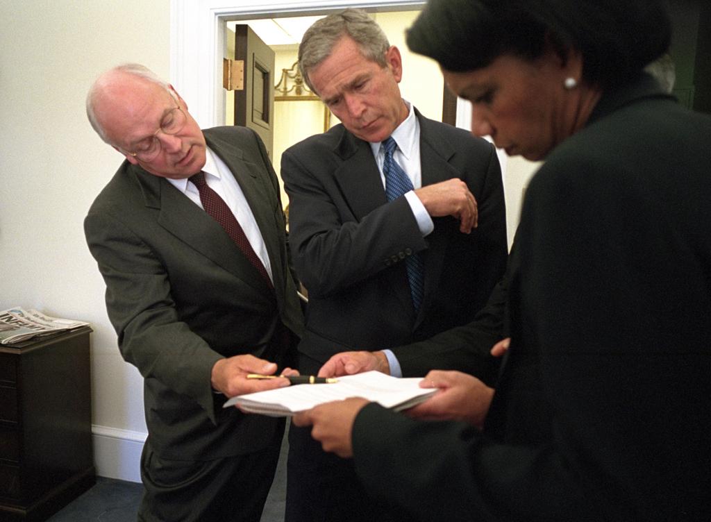 President George W. Bush looks over a briefing paper with Vice President Dick Cheney and National Security Advisor Dr. Condoleezza Rice, September 12, 2001, outside the Oval Office. (P7176-33)