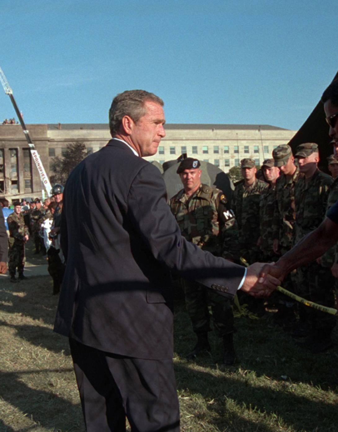 President George W. Bush greets rescue workers, firefighters and military personnel, September 12, 2001, while surveying damage caused by the previous day's terrorist attacks on the Pentagon in Arlington, Virginia. (P7234-21)