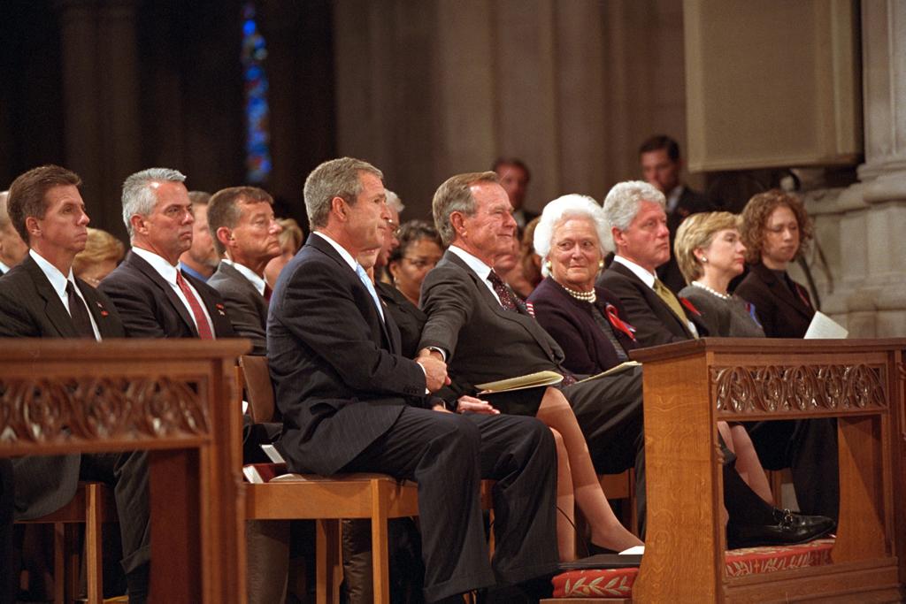 President George W. Bush grasps the hand of his father, former President George H. W. Bush, September 14, 2001, after speaking at the service for America's National Day of Prayer and Remembrance at the National Cathedral in Washington, D.C. (P7338-30)