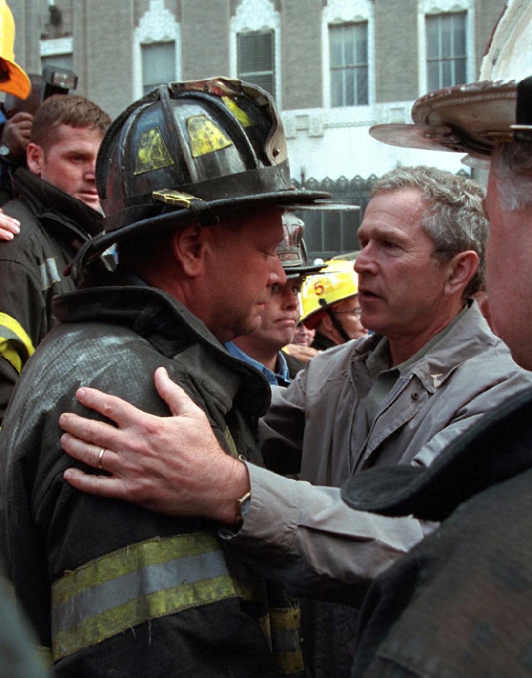 President George W. Bush embraces a firefighter at the site of the World Trade Center, September 14, 2001, during his visit to New York City. (P7371-06a)
