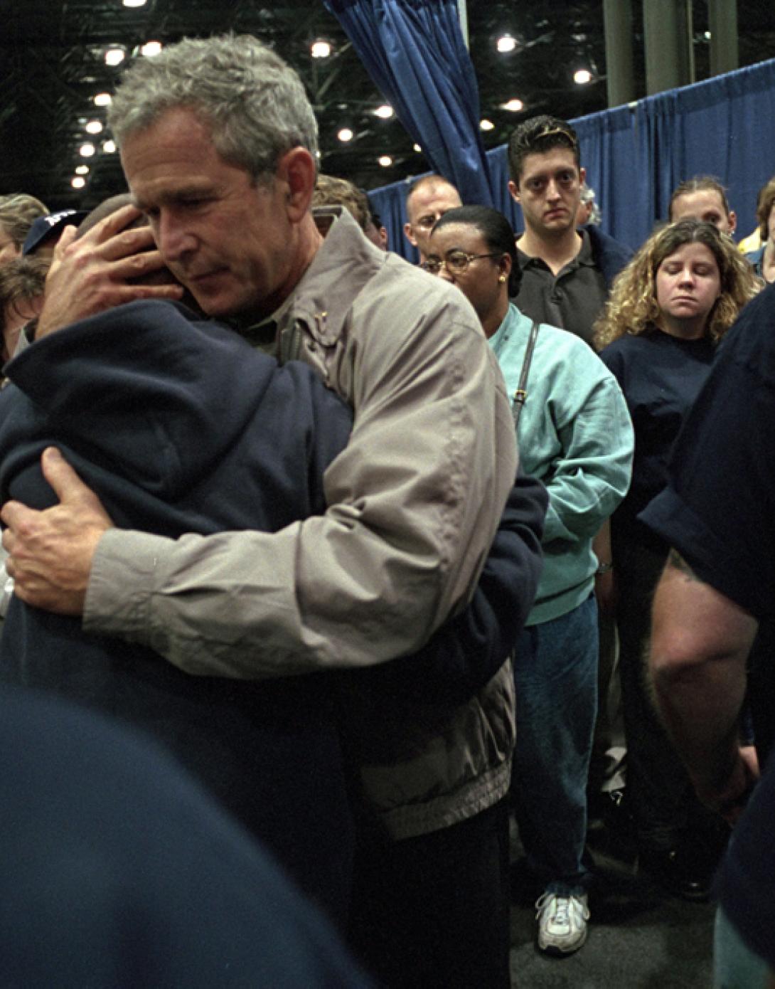 President George W. Bush hugs families of victims of the World Trade Center disaster.