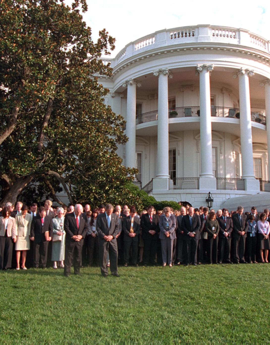 President George W. Bush and Vice President Dick Cheney are joined by White House staff members, September 18, 2001, as they observe a moment of silence on the White House South Lawn. (P7492-06)