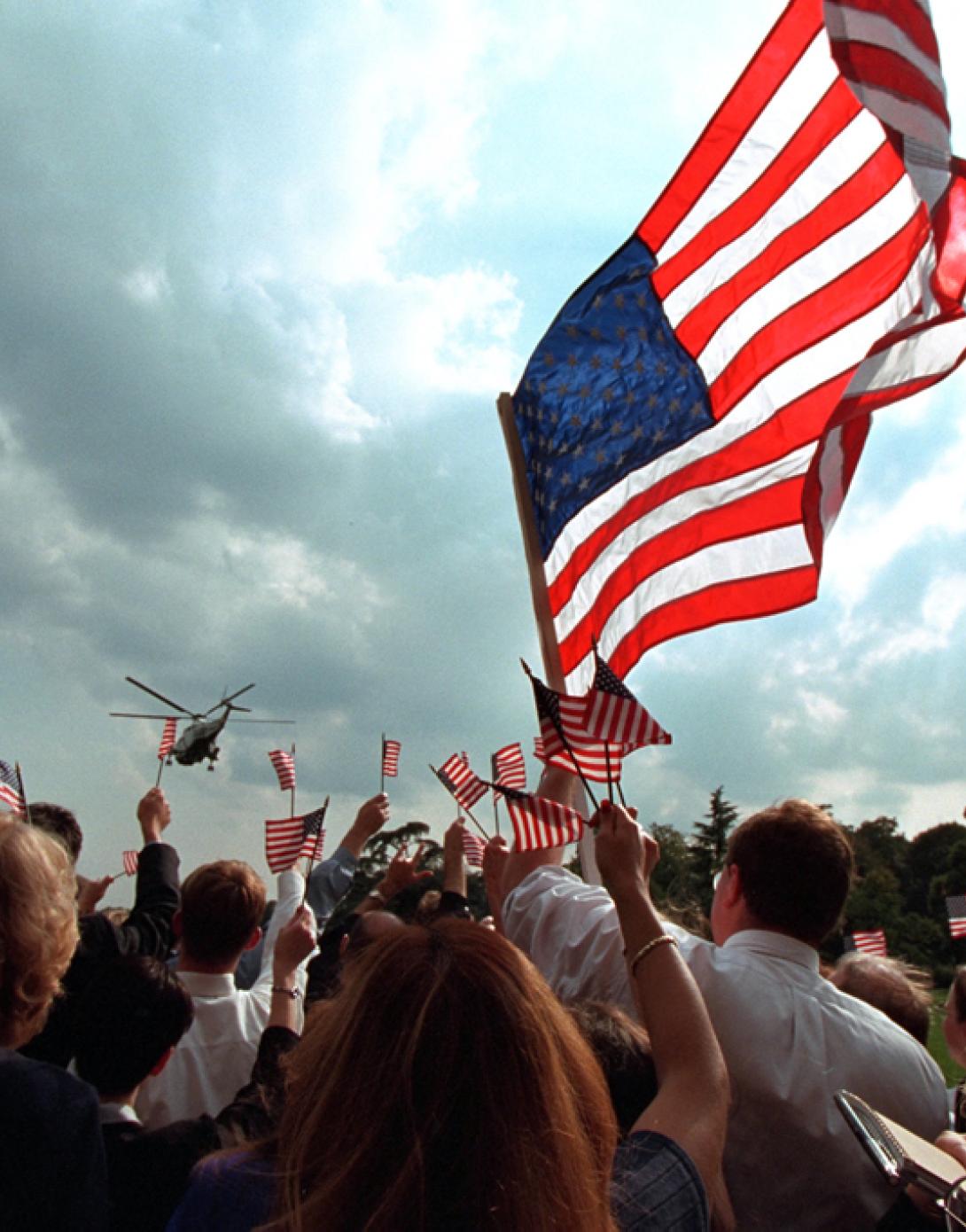 Staff members gathered on the South Lawn of the White house wave American flags, September 21, 2001, as President George W. Bush and Mrs. Laura Bush depart for Camp David aboard Marine One. (P7680-23)