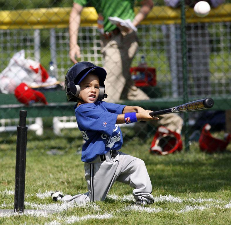 A player hits the ball during the season opener.