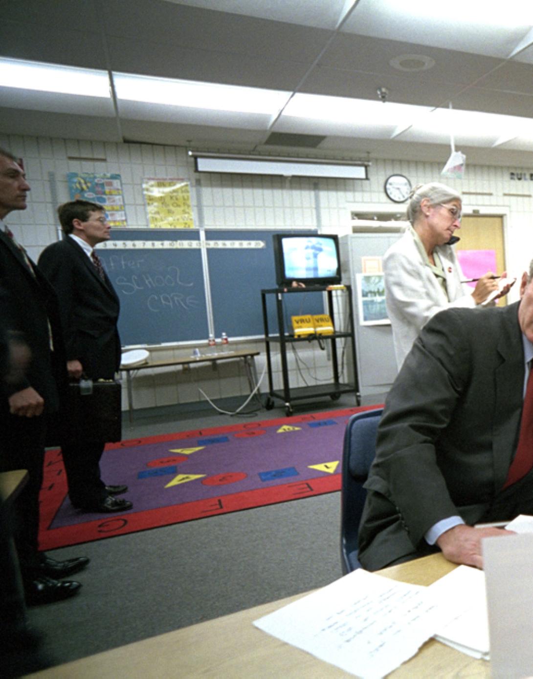 President George W. Bush and White House Staff watch news coverage of Flight 175 striking the South Tower of the World Trade Center at Emma E. Booker Elementary School in Sarasota, Florida, September 11, 2001.