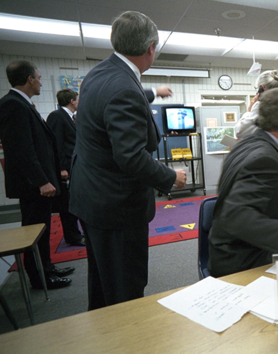 President George W. Bush watches news footage from Emma E. Booker Elementary School in Sarasota, Florida, of Flight 175 hitting the South Tower of the World Trade Center, September 11, 2001.