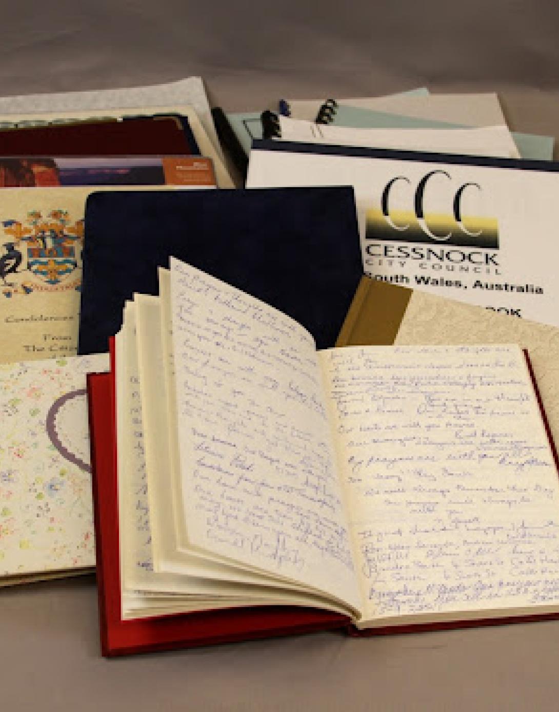 This photograph of a spread of condolence books sent in from Australia illustrates the abundance and variety of books sent in from throughout the world.
