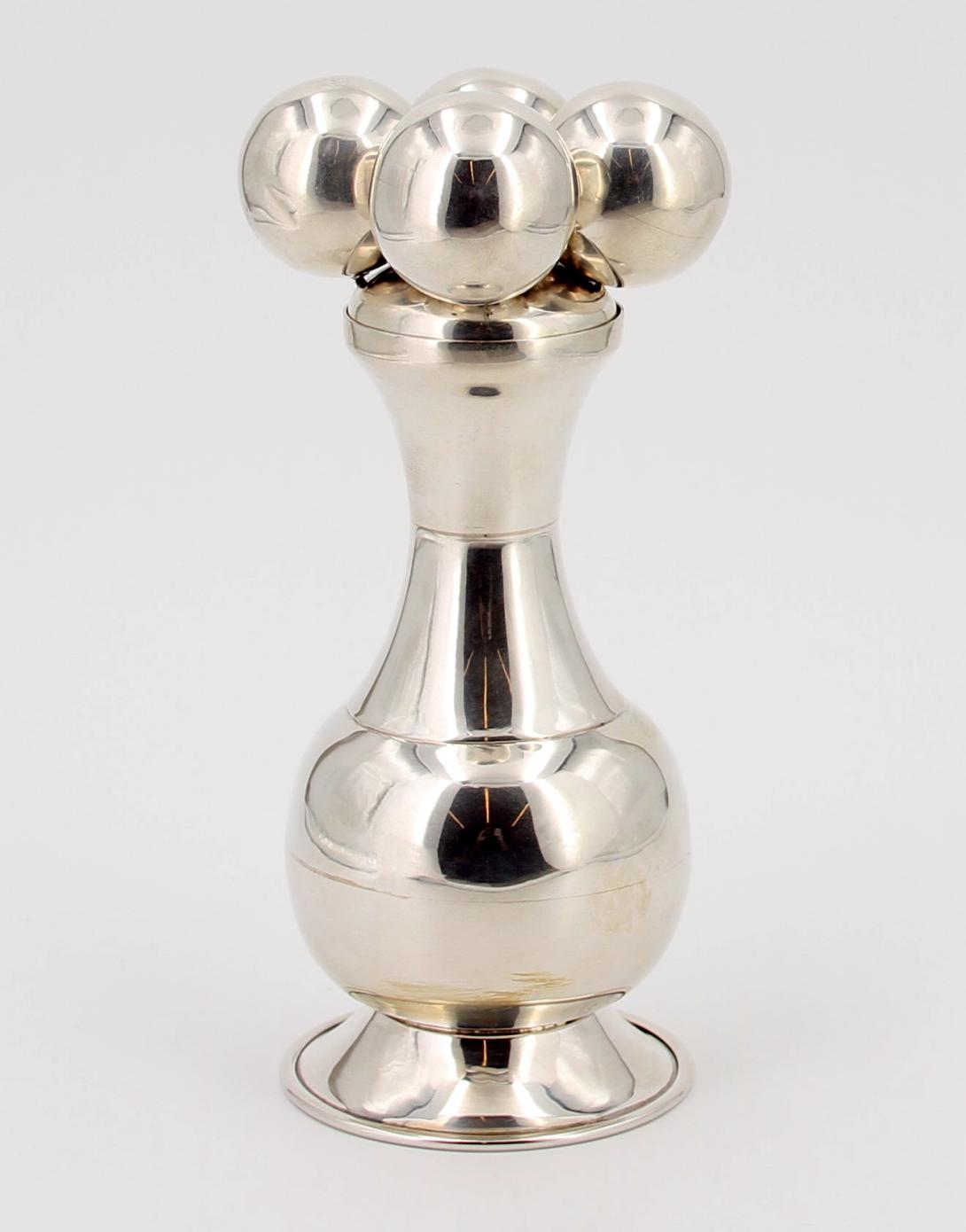 Silver container with removable lid that represents an indigenous artifact; held in a blue velvet hinged box with the coat of arms of Colombia on the lid. Presented to President Bush during a working visit to Washington, D. C. in 2007. Gifted by Alvaro Uribe, President of the Republic of Colombia.