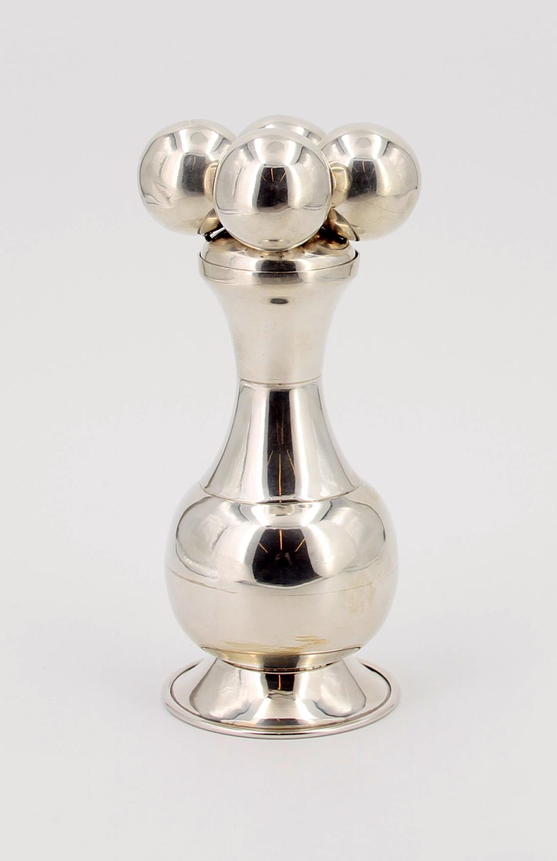 Silver container with removable lid that represents an indigenous artifact; held in a blue velvet hinged box with the coat of arms of Colombia on the lid. Presented to President Bush during a working visit to Washington, D. C. in 2007. Gifted by Alvaro Uribe, President of the Republic of Colombia.