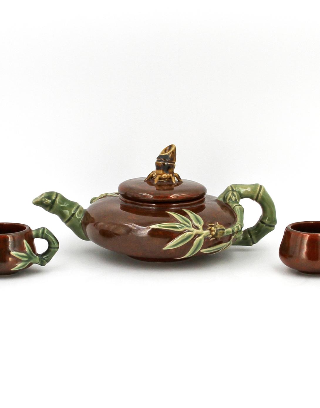 Brown glazed tea set, including a teapot with lid and four cups, all with green bamboo handles and designs. Presented by Donald Tsang Yam-Kuen, Chief Executive of the Hong Kong Special Administrative Region of the People’s Republic of China.