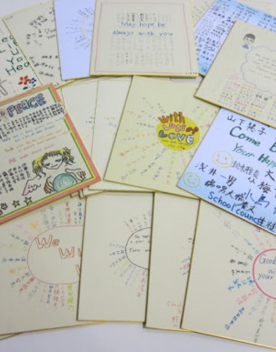 Students from homeroom classes at this school in Japan draw pictures and sign their names on wooden boards with gold painted trim.