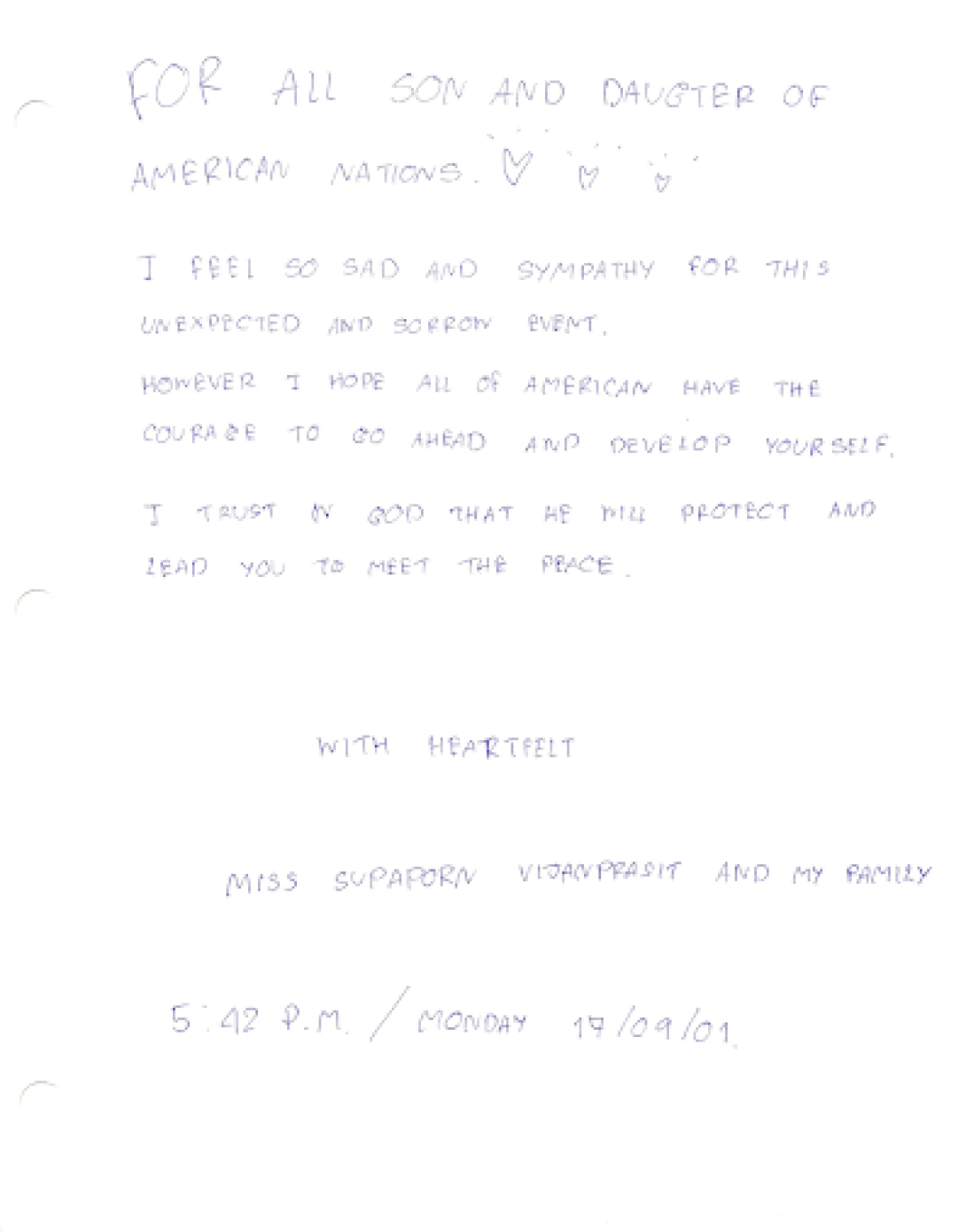 Supaporn Vijanprasit and family from The Kingdom of Thailand write a message of sympathy in a condolence book.